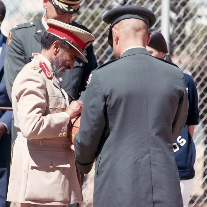 Haile Selassie signing basketball